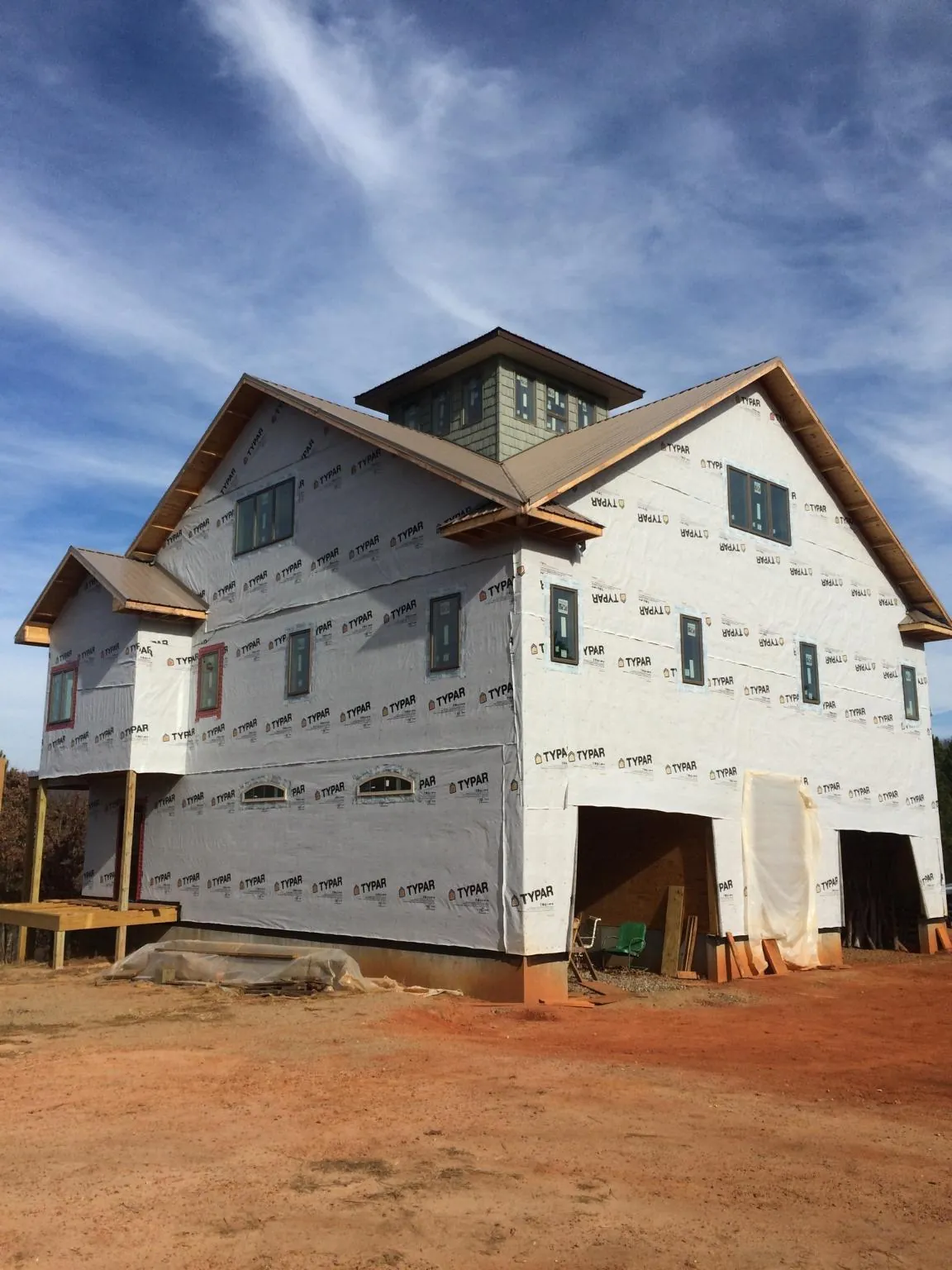 New two story house under construction with a cupola and gabled roofs in Whitesville